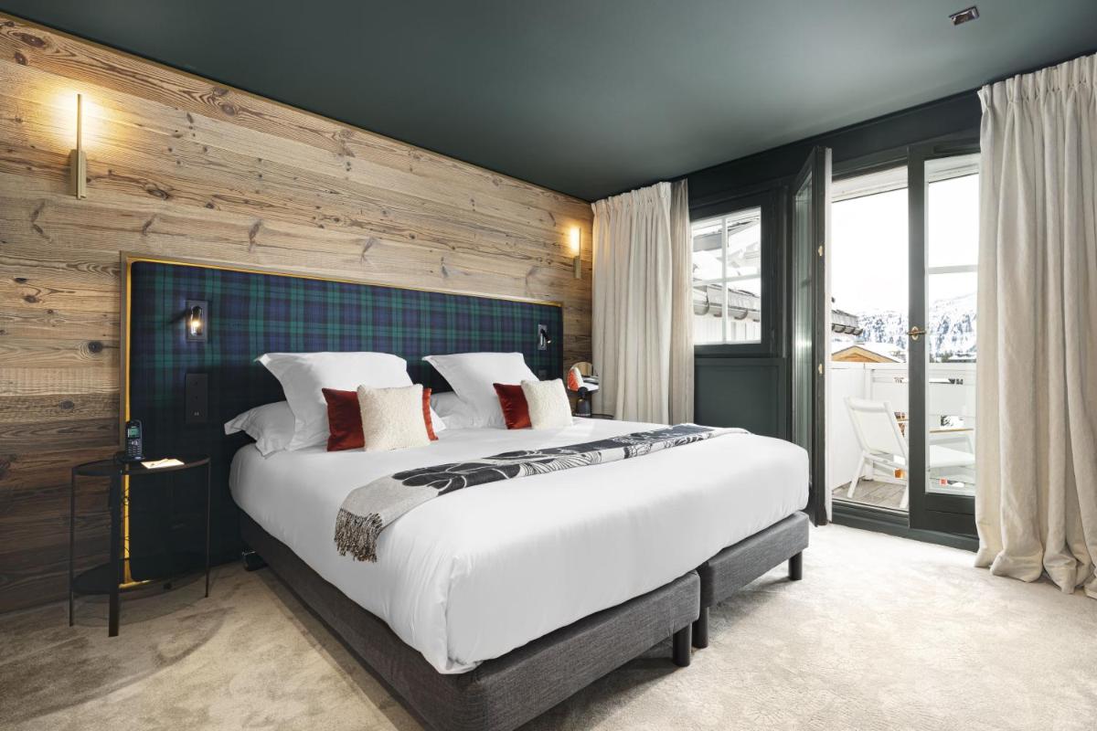 Un ou plusieurs lits dans un hébergement de l'établissement Hotel Le Chabichou