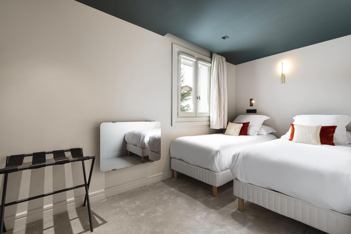 Un ou plusieurs lits dans un hébergement de l'établissement Hotel Le Chabichou