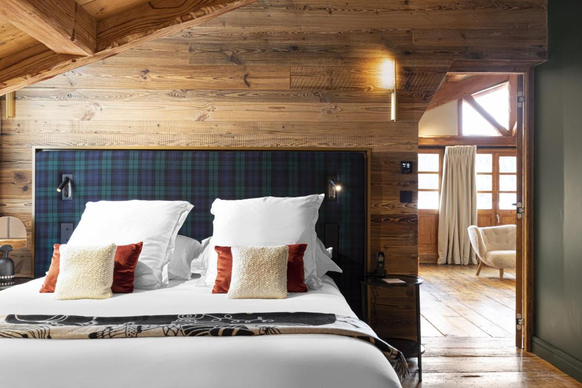 Un ou plusieurs lits dans un hébergement de l'établissement Hotel Le Chabichou