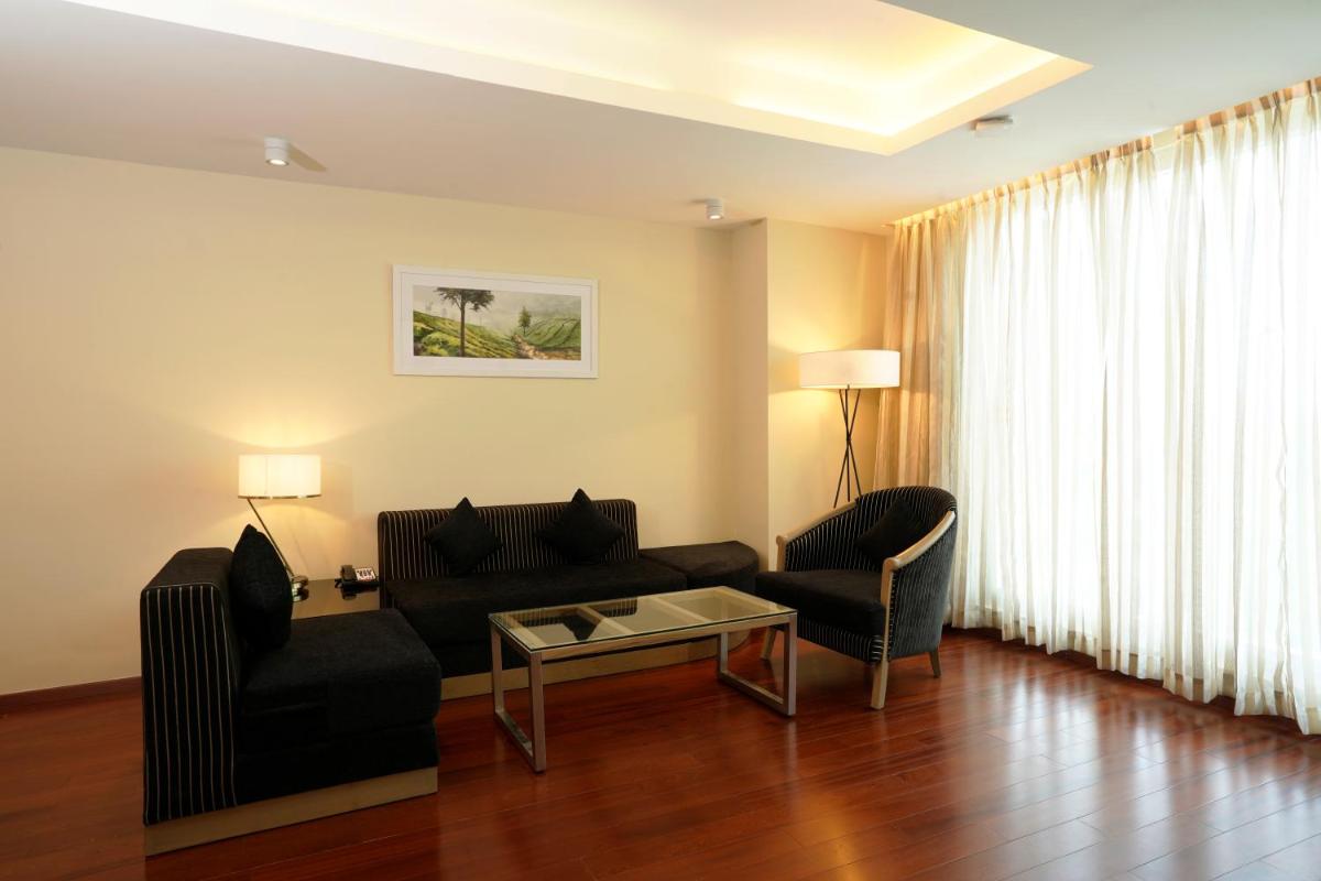 a living room with a couch and a table at O by Tamara, Trivandrum in Trivandrum