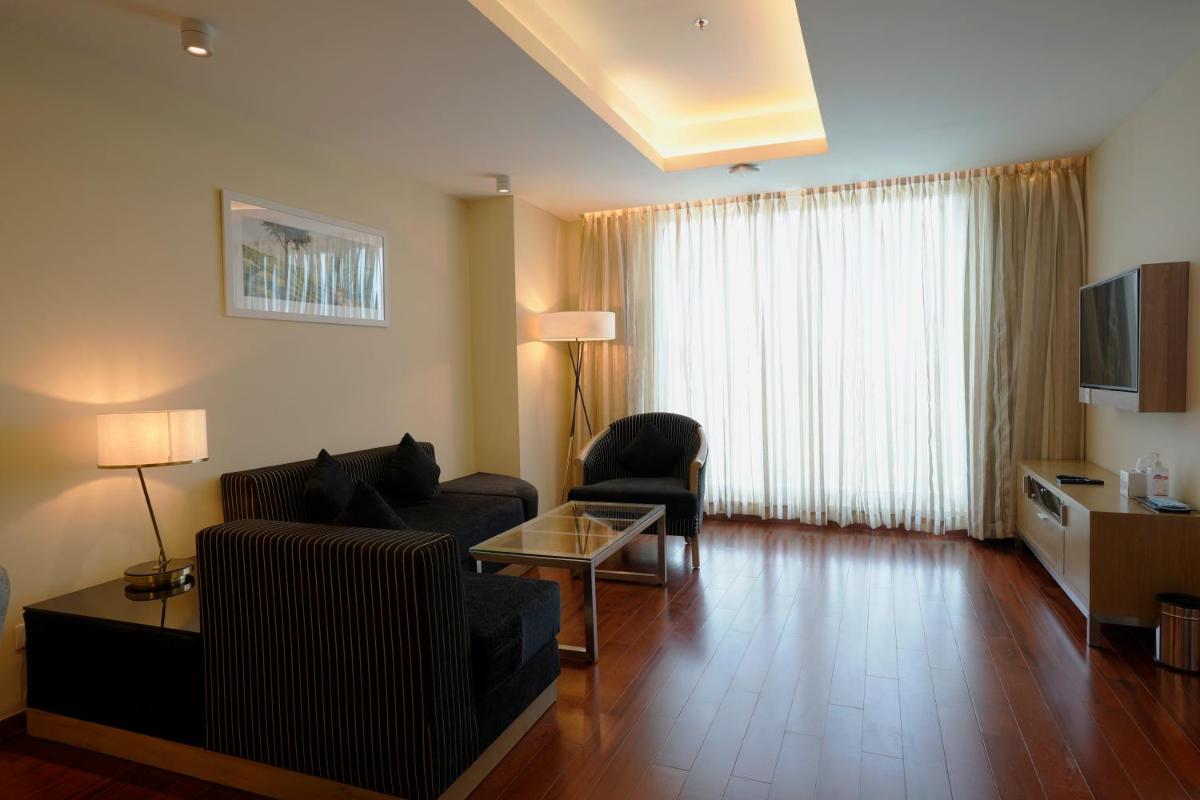 a living room with a couch and a table at O by Tamara, Trivandrum in Trivandrum