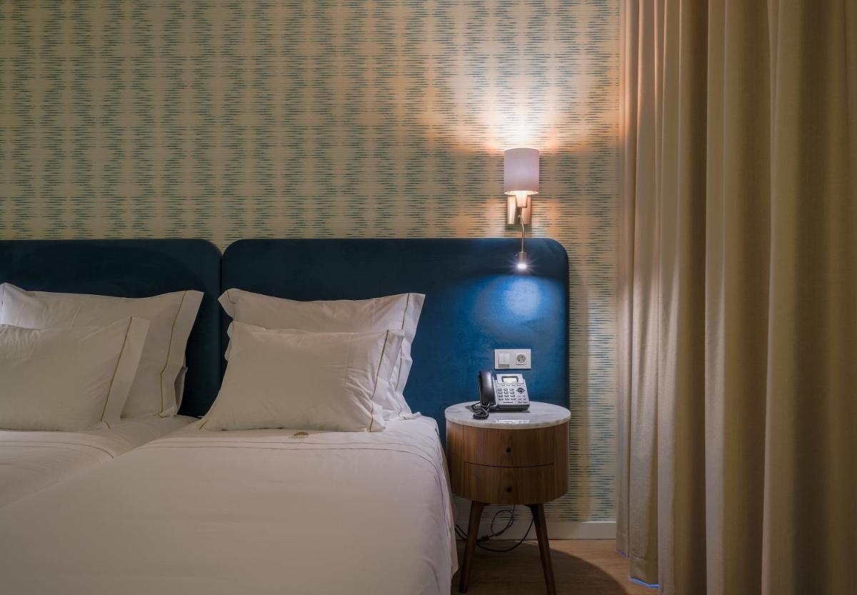 Uma cama ou camas num quarto em Hotel Vouga