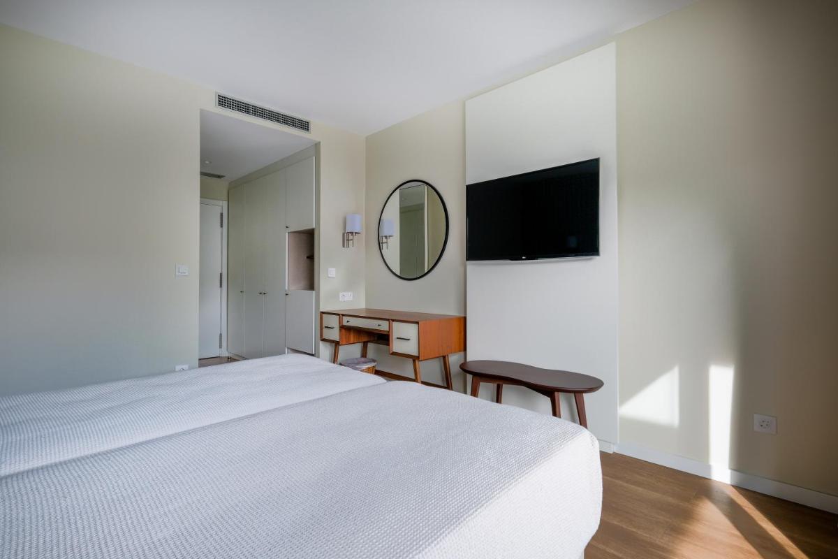 Uma cama ou camas num quarto em Hotel Vouga
