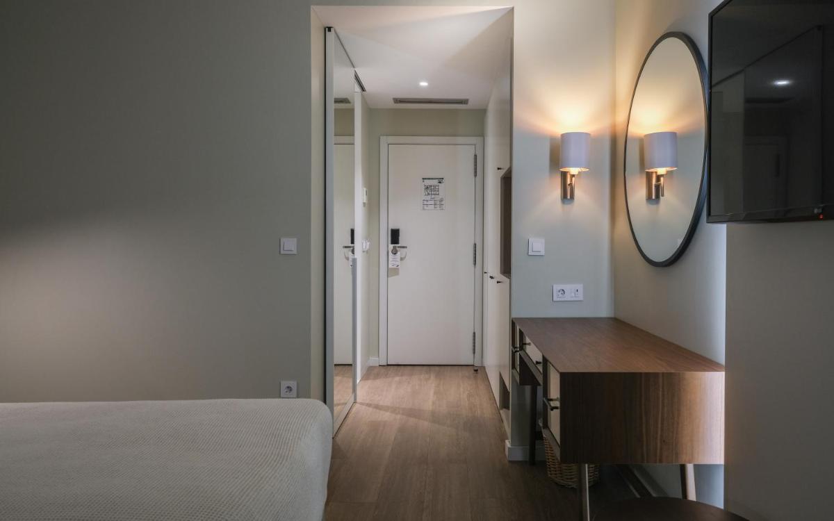 Uma cama ou camas num quarto em Hotel Vouga