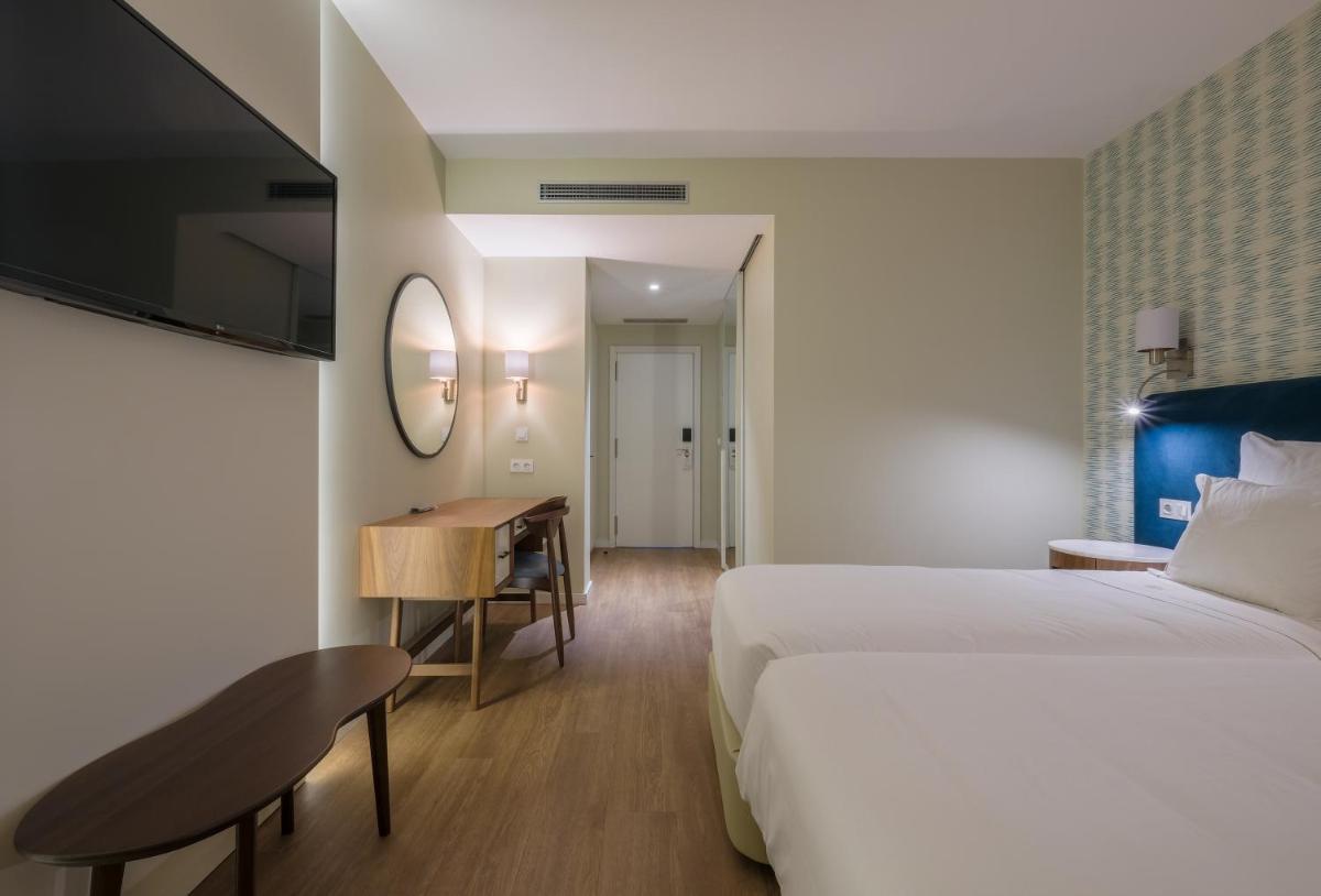 Uma cama ou camas num quarto em Hotel Vouga