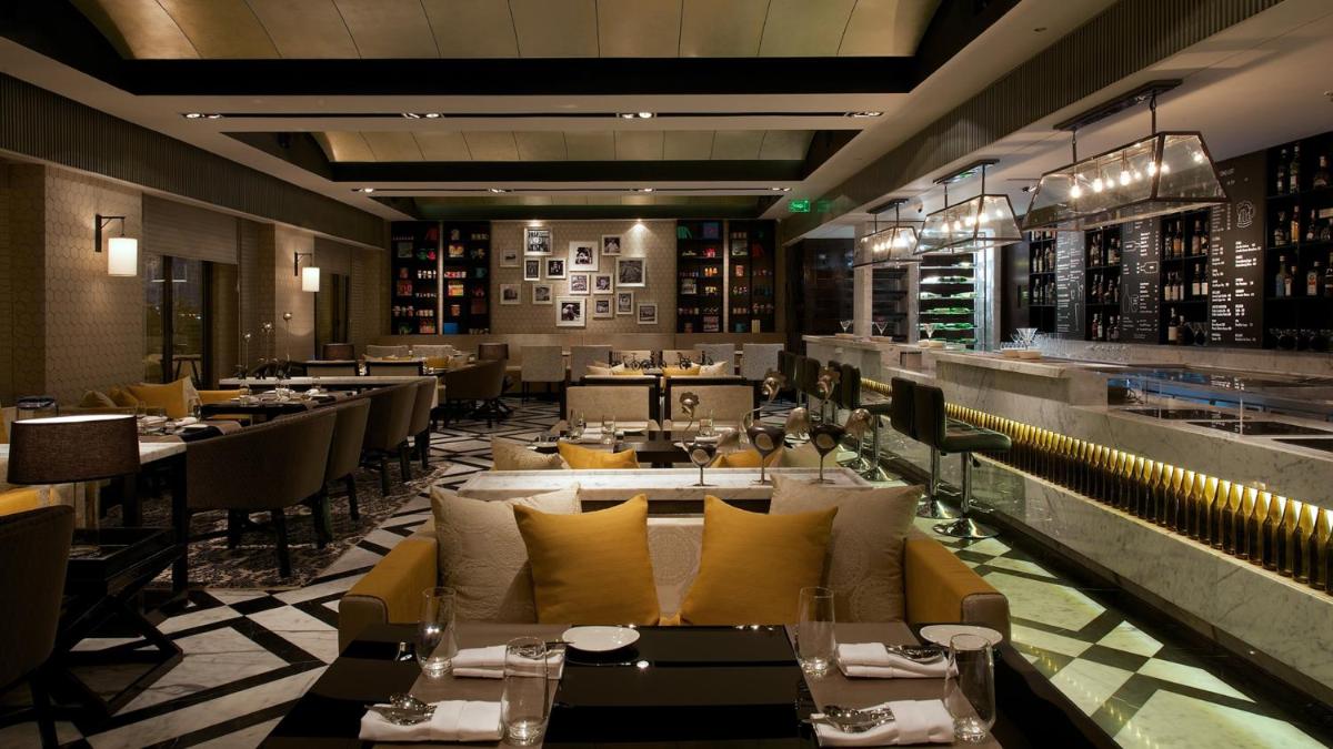 a restaurant with couches and tables and a bar at InterContinental Marine Drive Mumbai by IHG in Mumbai