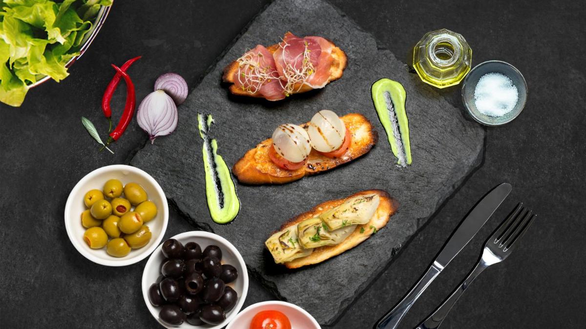 a table with a bunch of food on it at InterContinental Marine Drive Mumbai by IHG in Mumbai
