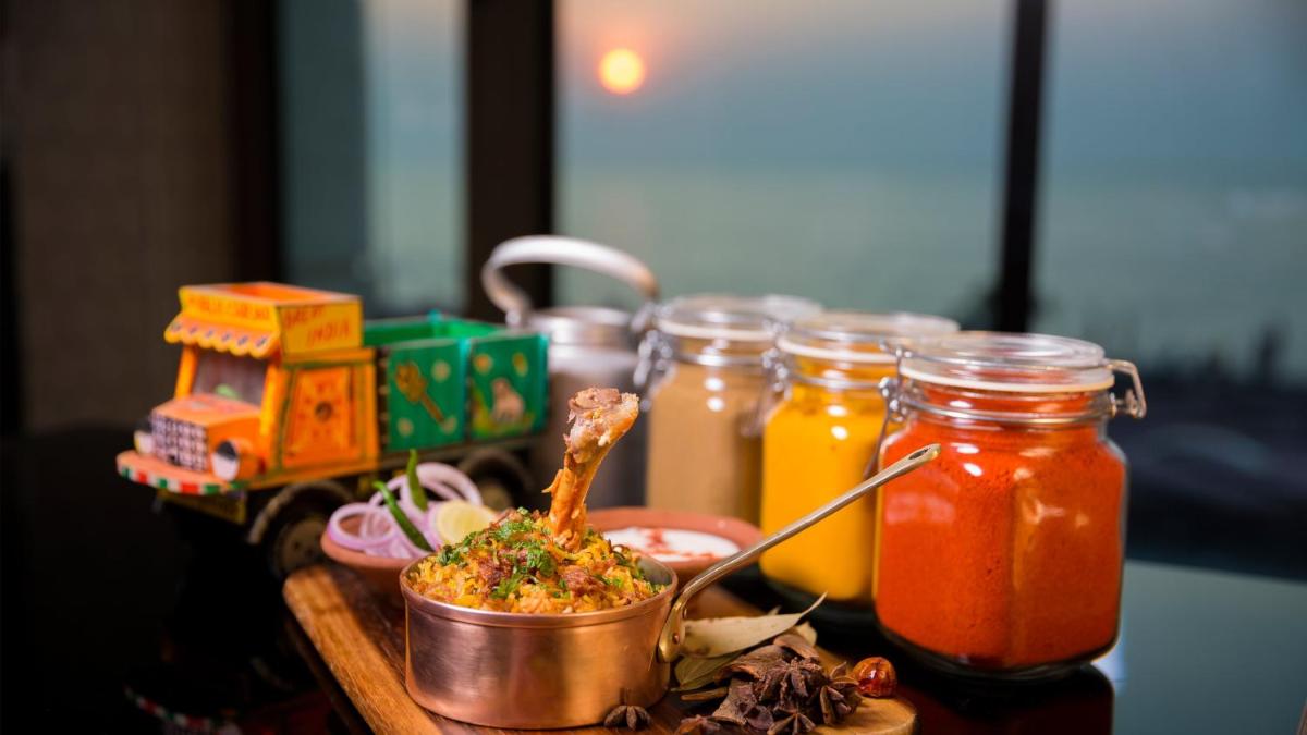 a table with a bowl of food and jars of sauce at InterContinental Marine Drive Mumbai by IHG in Mumbai