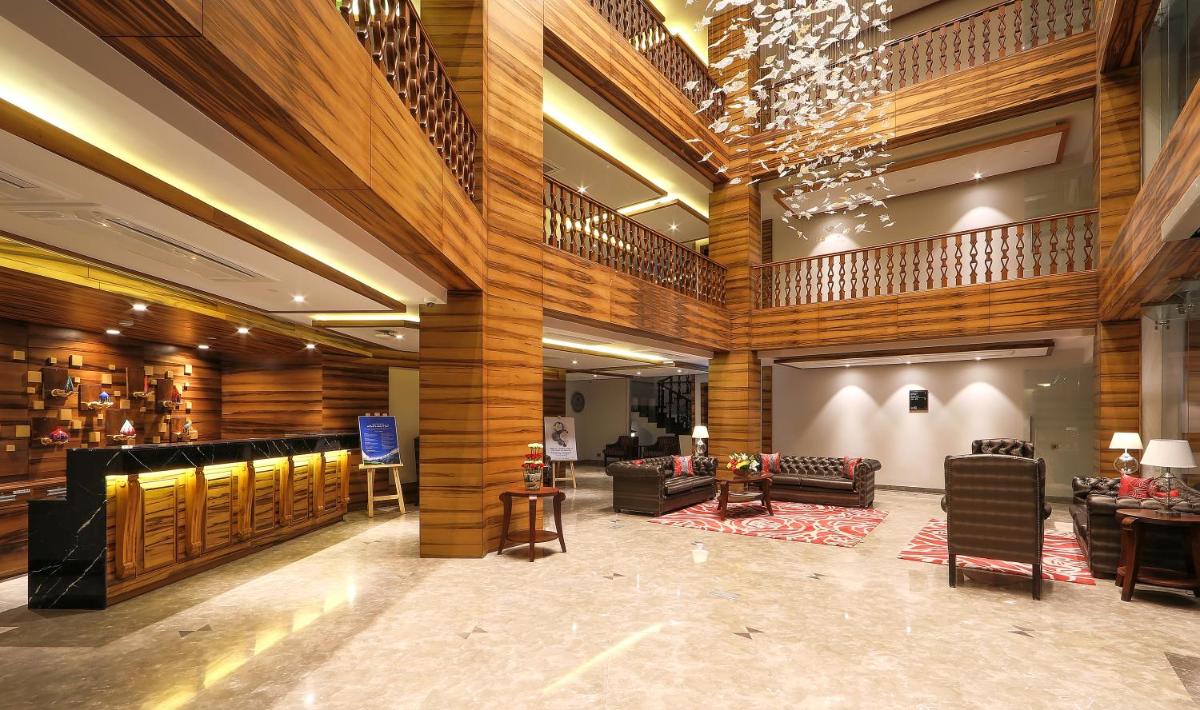 a lobby of a hotel with wooden walls and furniture at Welcomhotel by ITC Hotels, Shimla in Shimla