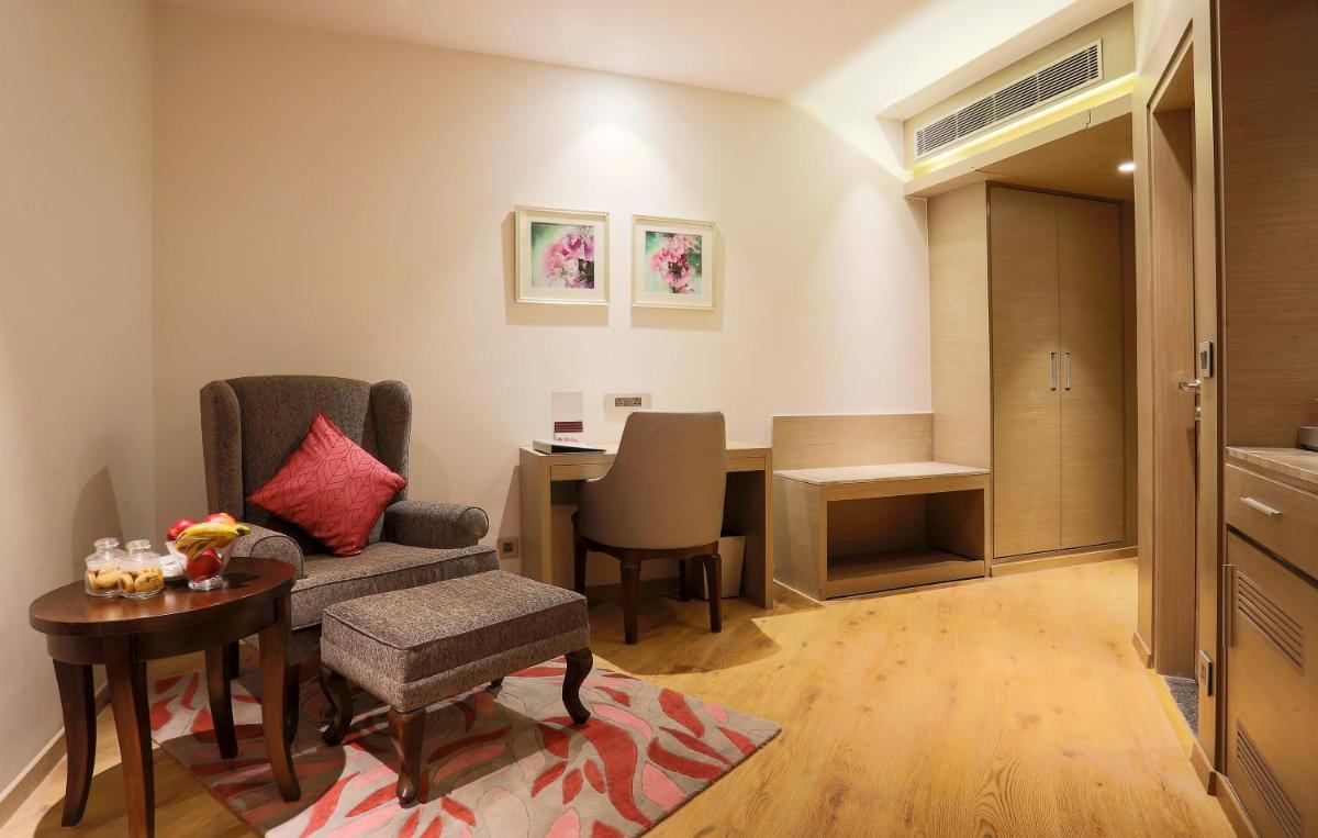 a living room with a chair and a table and a desk at Welcomhotel by ITC Hotels, Shimla in Shimla