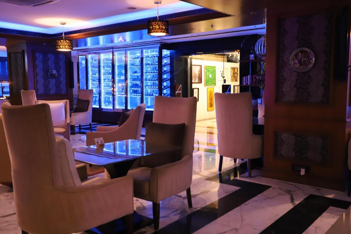 a dining room with a table and chairs at Sofitel Mumbai BKC in Mumbai