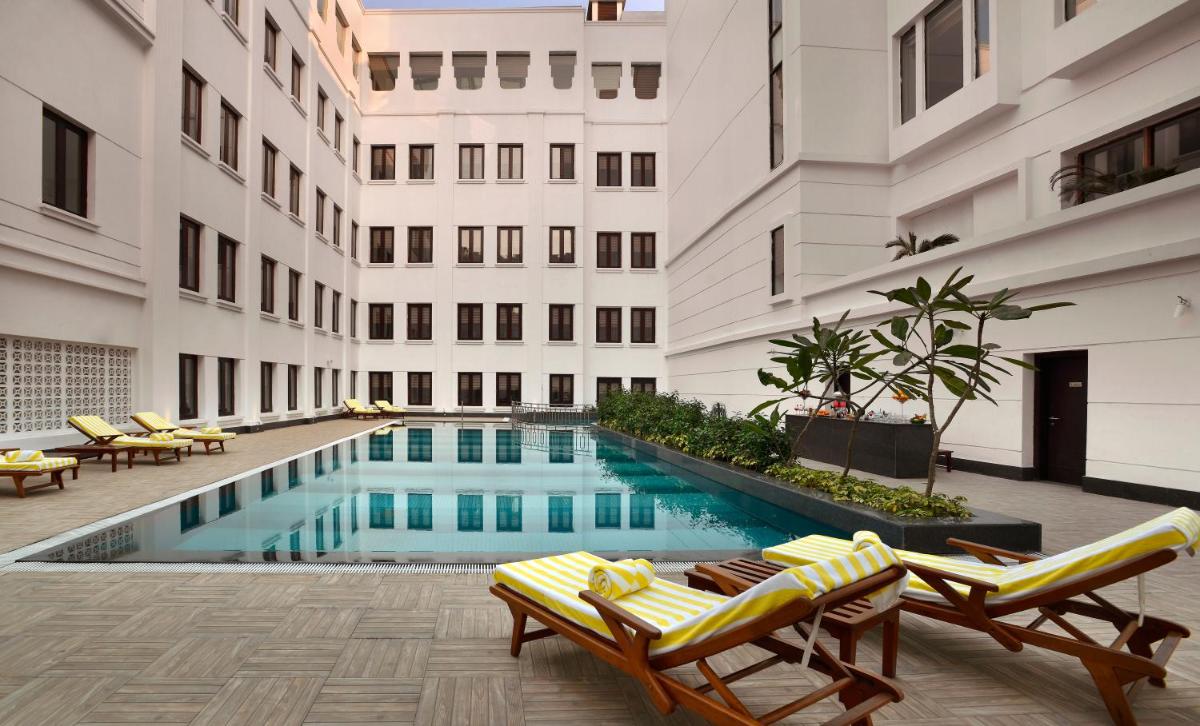 a swimming pool in the middle of a building at The Lalit Great Eastern Kolkata in Kolkata a swimming pool in the middle of a building at The Lalit Great Eastern Kolkata in Kolkata