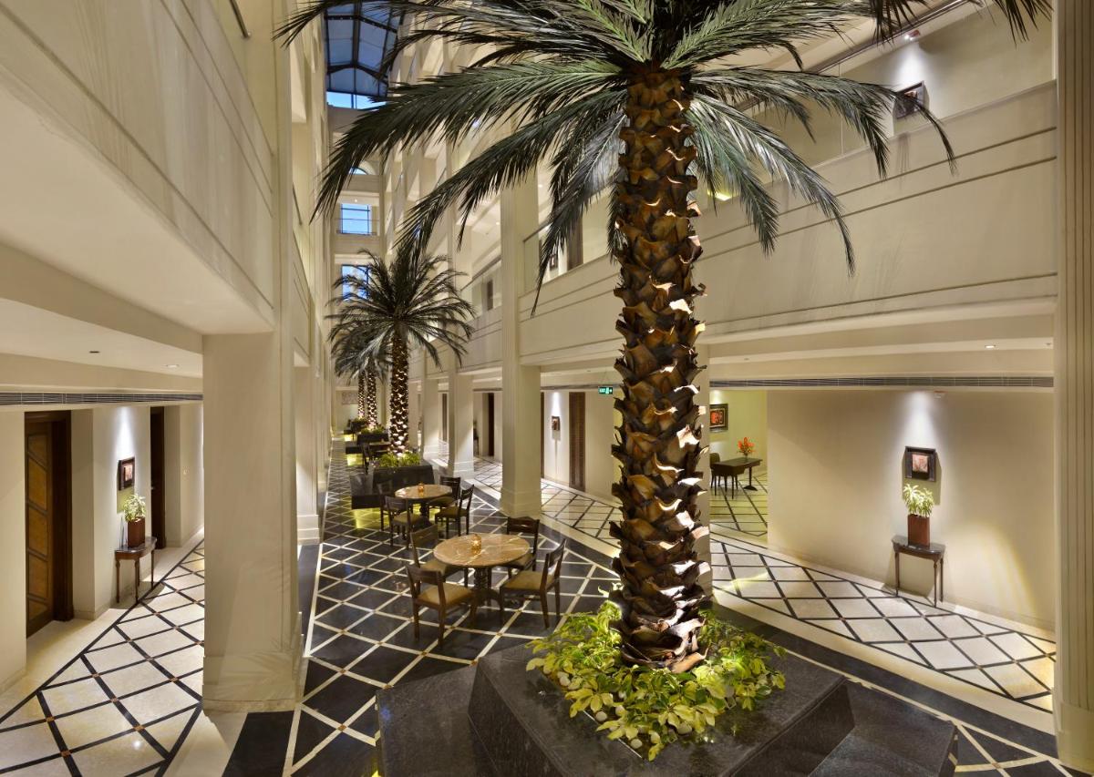 a palm tree in the lobby of a hotel at The Lalit Great Eastern Kolkata in Kolkata a palm tree in the lobby of a hotel at The Lalit Great Eastern Kolkata in Kolkata