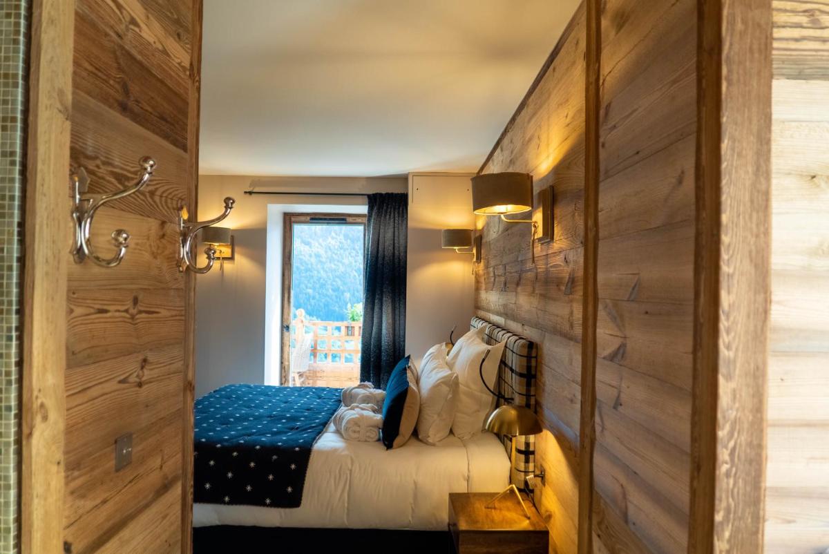 Un ou plusieurs lits dans un hébergement de l'établissement Hotel Le V de Vaujany