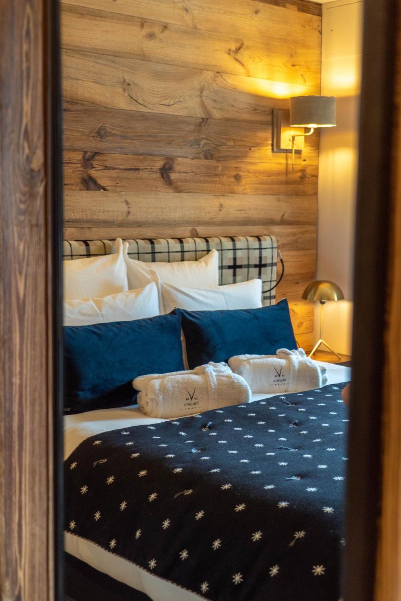 Un ou plusieurs lits dans un hébergement de l'établissement Hotel Le V de Vaujany