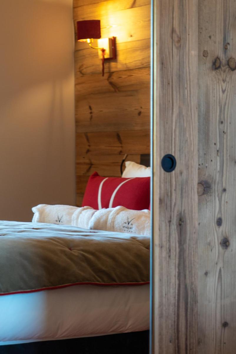 Un ou plusieurs lits dans un hébergement de l'établissement Hotel Le V de Vaujany