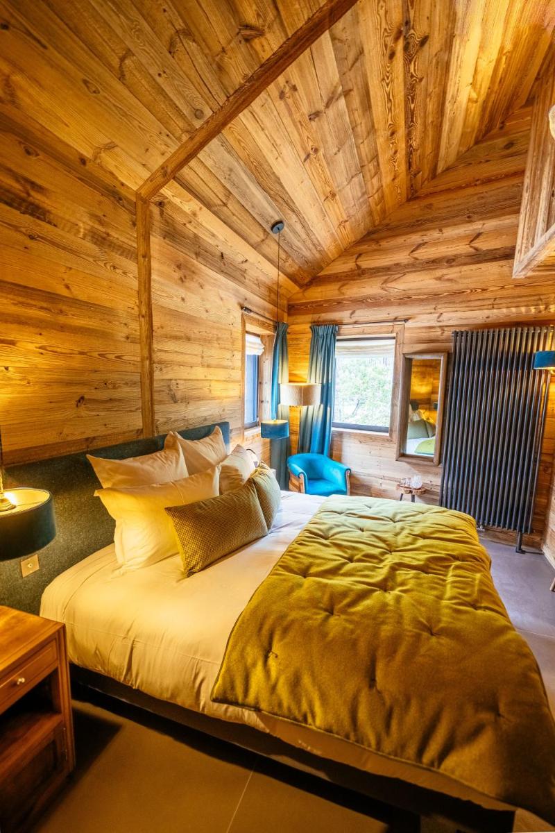 Un ou plusieurs lits dans un hébergement de l'établissement Hotel Le V de Vaujany