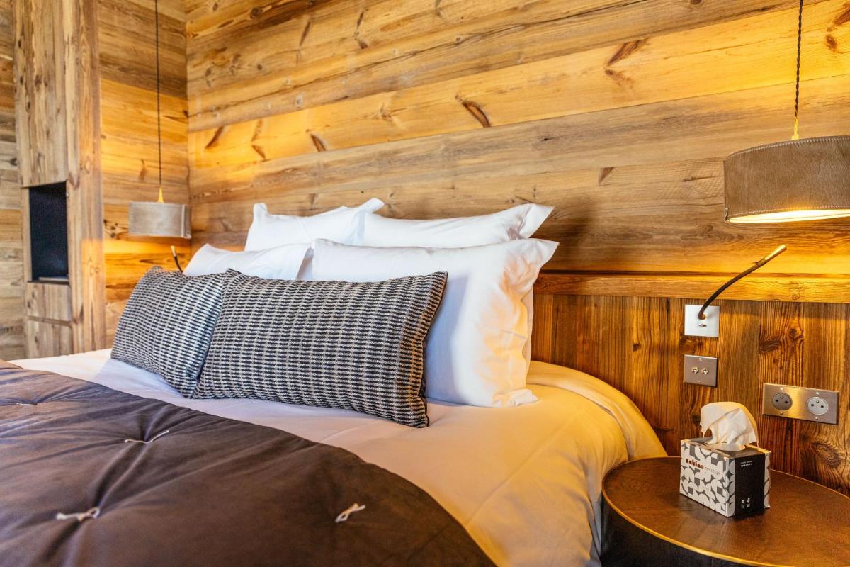 Un ou plusieurs lits dans un hébergement de l'établissement Hotel Le V de Vaujany