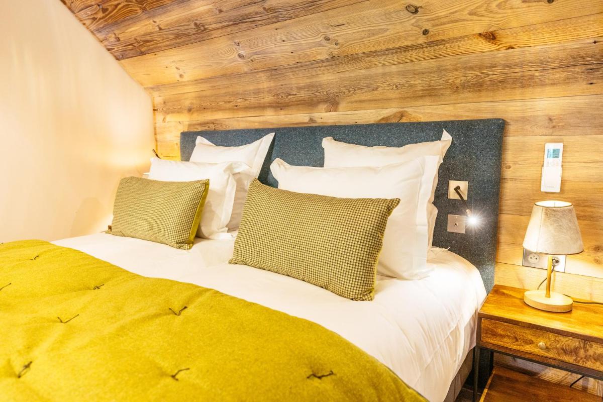 Un ou plusieurs lits dans un hébergement de l'établissement Hotel Le V de Vaujany