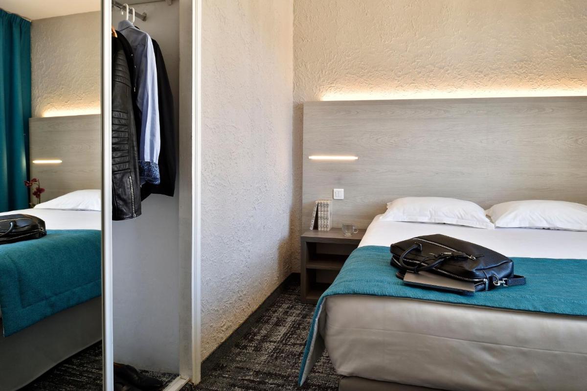 Un ou plusieurs lits dans un hébergement de l'établissement Hôtel Fesch & Spa