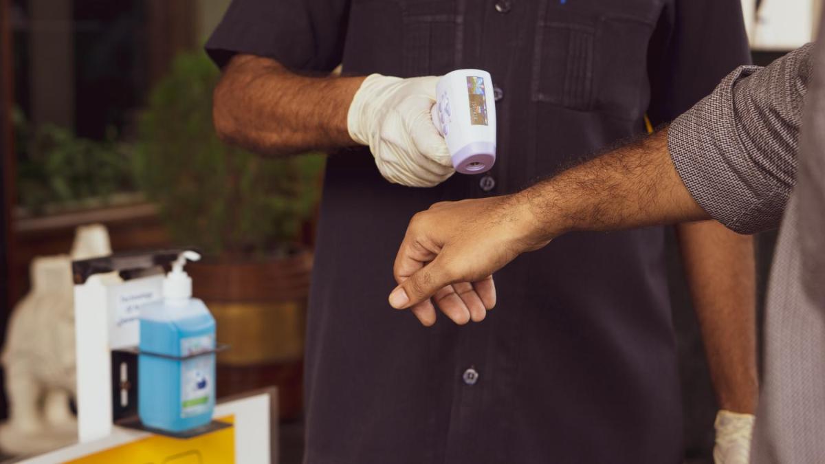a man holding a remote control in his hand at The Ummed Ahmedabad Airport in Ahmedabad