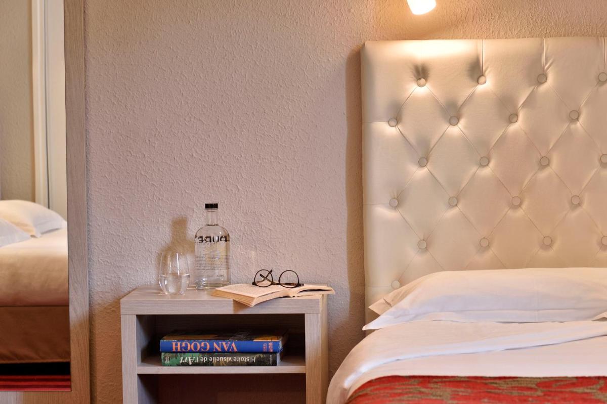 Un ou plusieurs lits dans un hébergement de l'établissement Hôtel Fesch & Spa