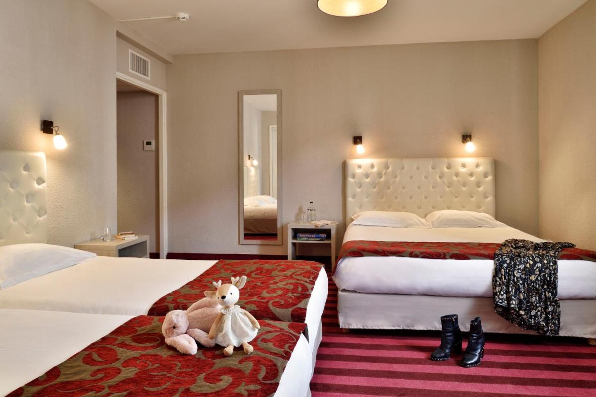 Un ou plusieurs lits dans un hébergement de l'établissement Hôtel Fesch & Spa