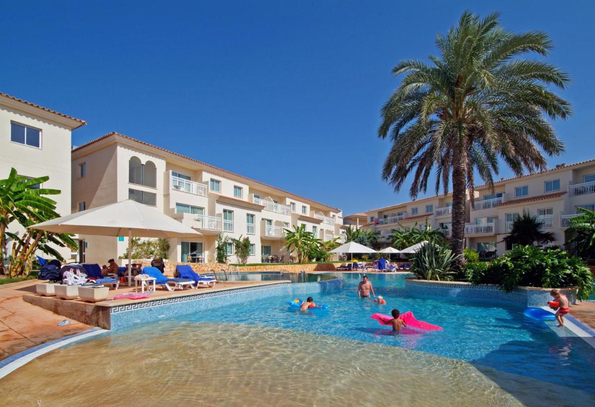 Un grupo de personas en la piscina de un resort. en Aparthotel Isla de Cabrera, en Colonia de Sant Jordi