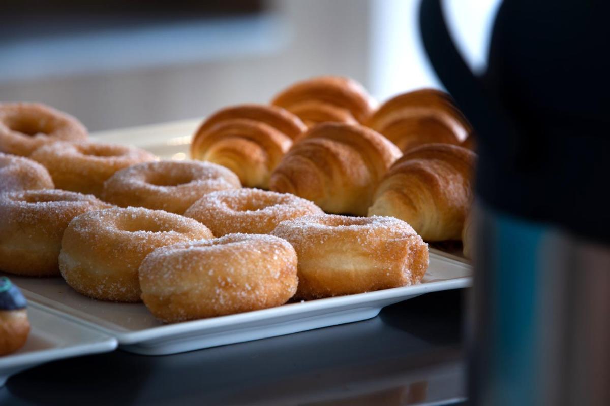a bunch of donuts sitting on a tray at Holiday Inn Bengaluru Racecourse by IHG in Bengaluru a bunch of donuts sitting on a tray at Holiday Inn Bengaluru Racecourse by IHG in Bengaluru