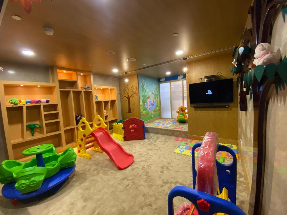 a room with a play area with a slide and a playground at Holiday Inn Agra MG Road an IHG Hotel in Agra