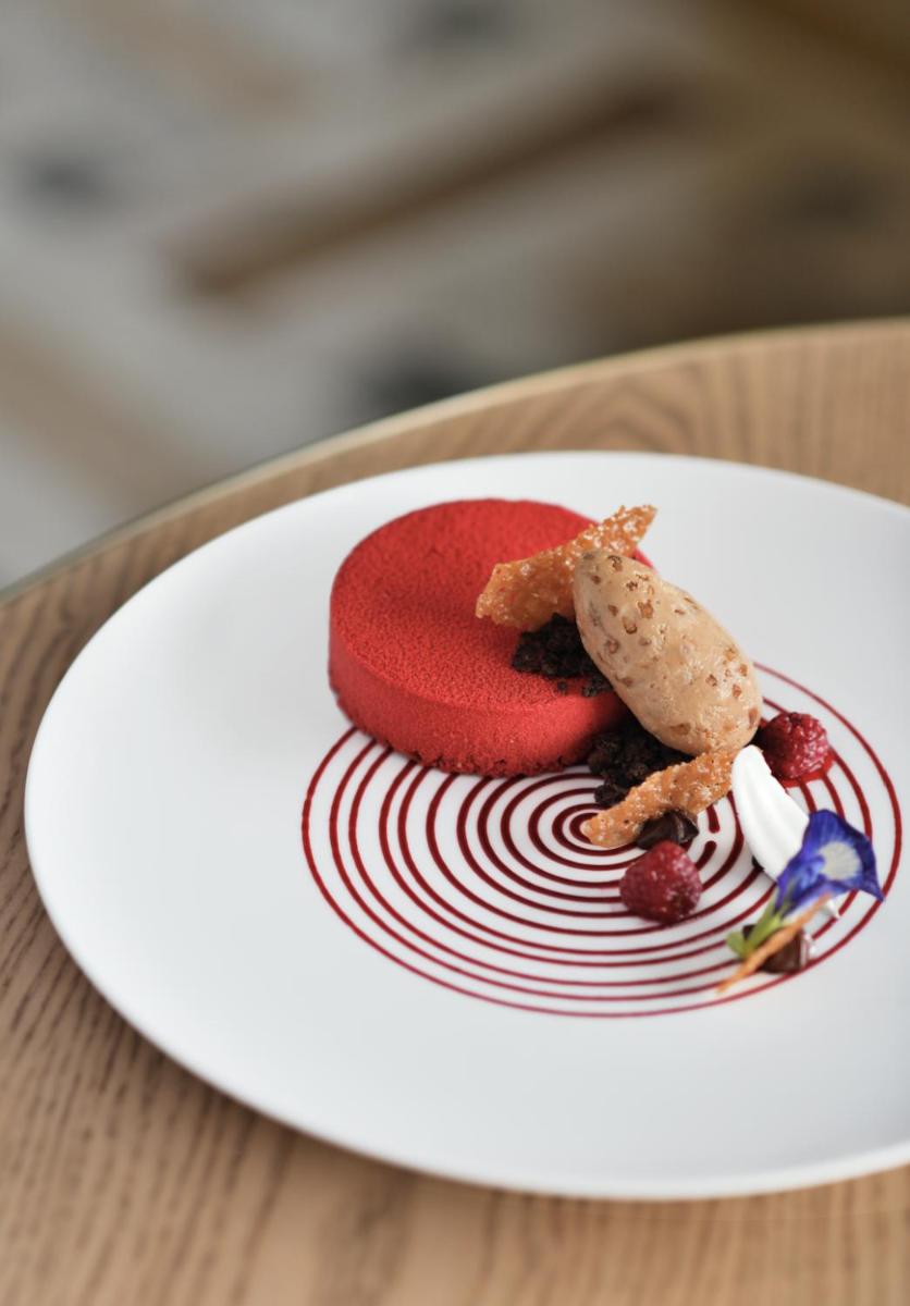 a white plate with a dessert on a table at Taj Mahal, New Delhi in New Delhi