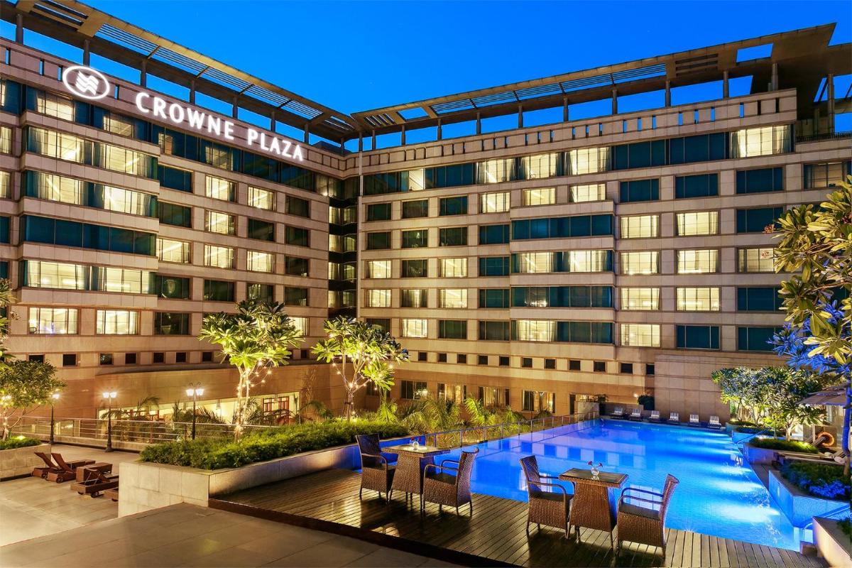 an exterior view of a hotel with a swimming pool at Crowne Plaza Today Gurugram by IHG in Gurgaon