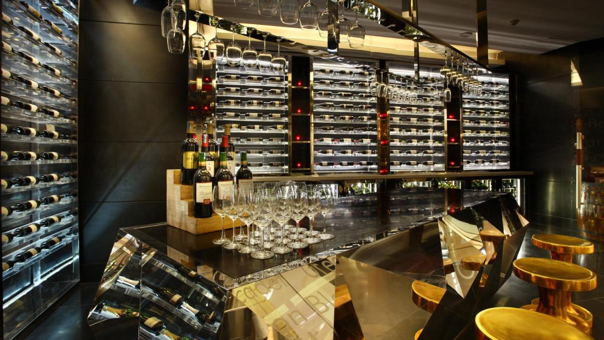 a wine tasting room with wine glasses and wine bottles at Crowne Plaza New Delhi Rohini by IHG in New Delhi a wine tasting room with wine glasses and wine bottles at Crowne Plaza New Delhi Rohini by IHG in New Delhi