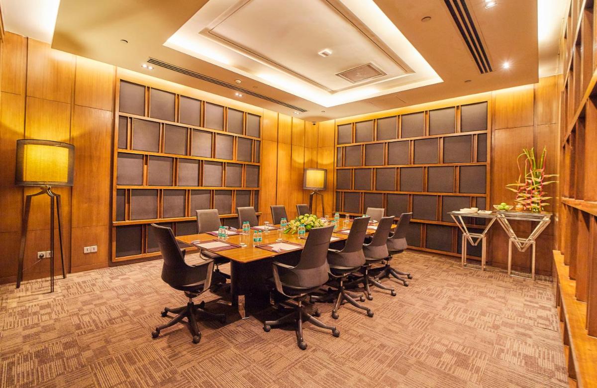 a conference room with a long table and chairs at Crowne Plaza New Delhi Rohini by IHG in New Delhi a conference room with a long table and chairs at Crowne Plaza New Delhi Rohini by IHG in New Delhi