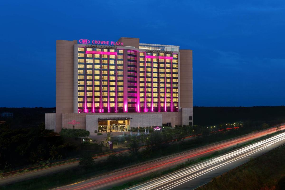 a building with pink lights on top of it at Crowne Plaza Kochi by IHG in Cochin
