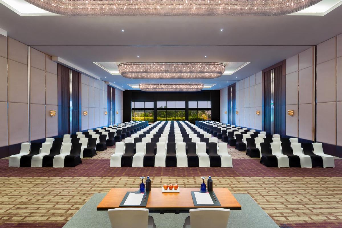 a large conference room with tables and chairs in it at Crowne Plaza Kochi by IHG in Cochin