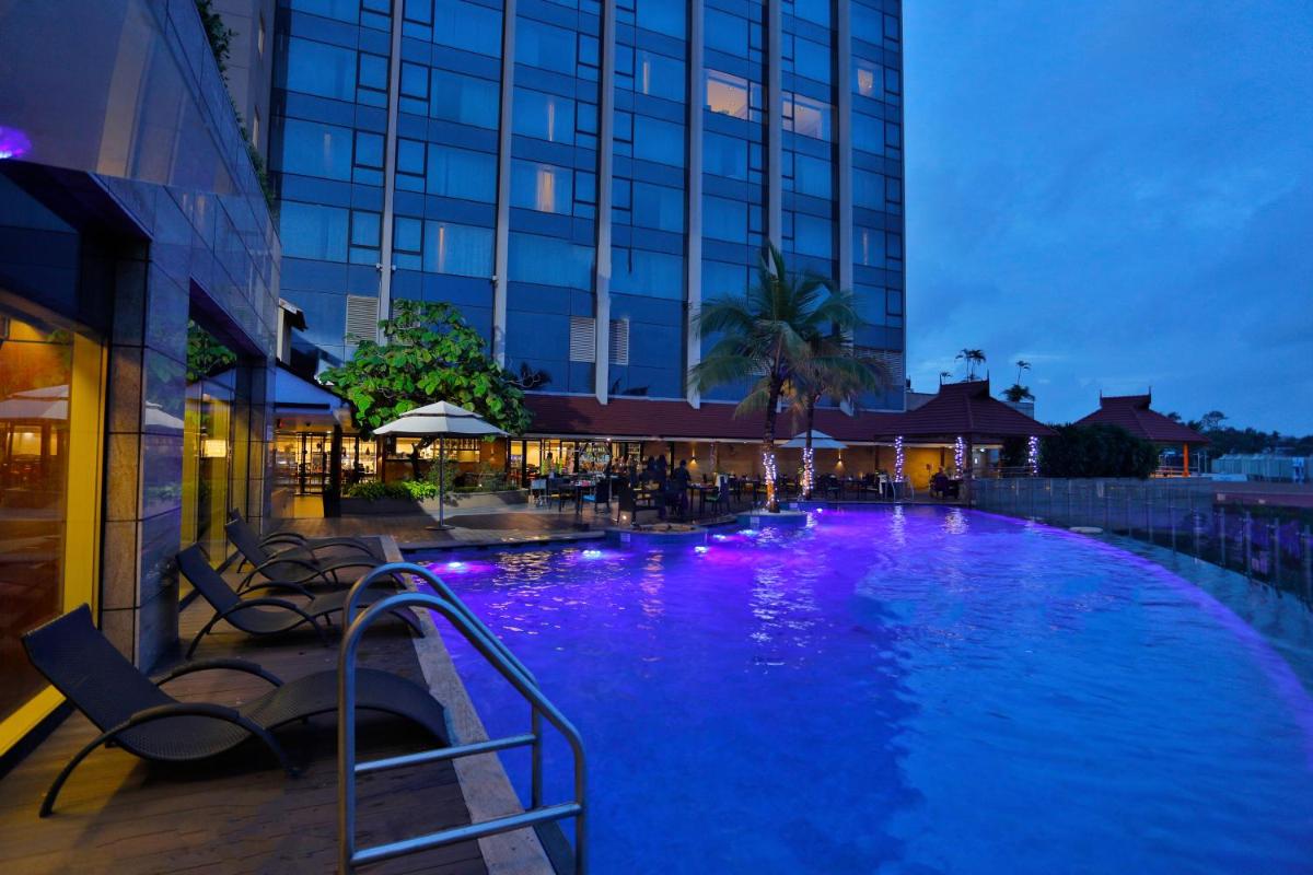 a swimming pool with purple lights in a hotel at Crowne Plaza Kochi by IHG in Cochin