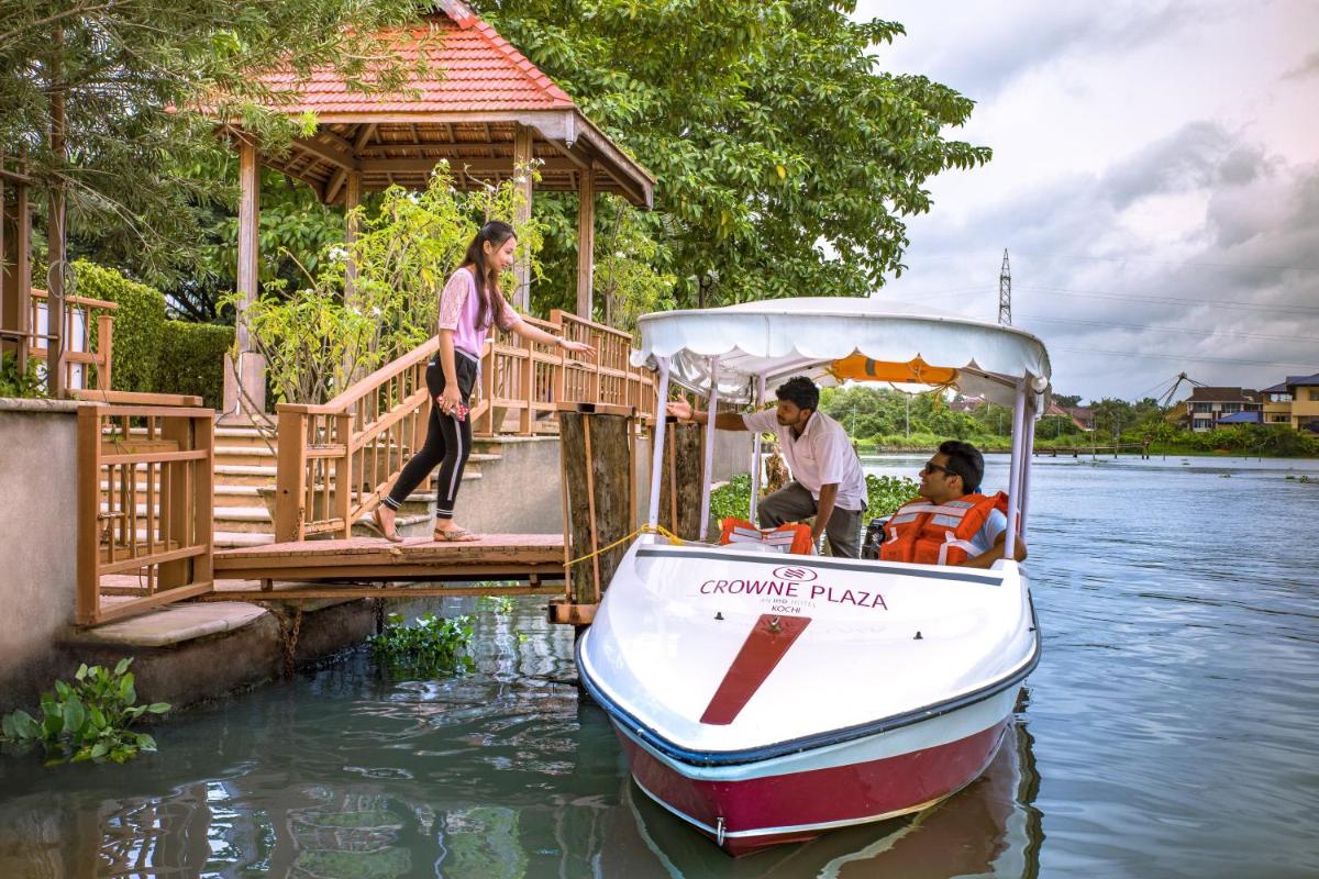 a group of people on a boat on the water at Crowne Plaza Kochi by IHG in Cochin