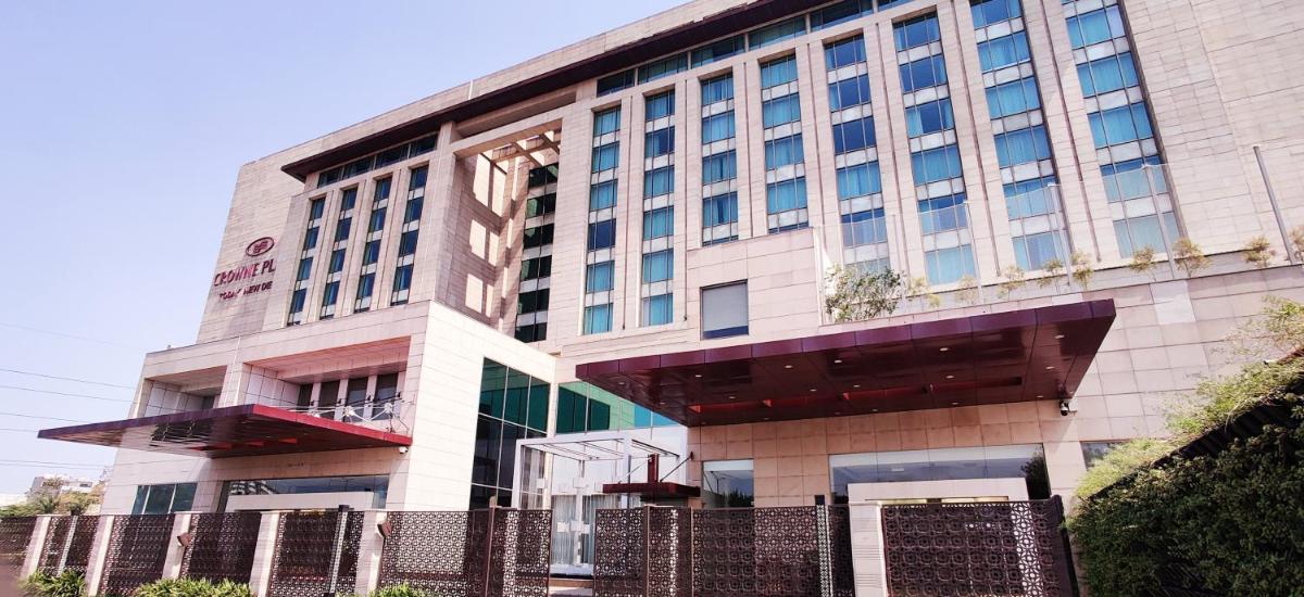 a large building with a fence in front of it at Crowne Plaza New Delhi Okhla by IHG in New Delhi