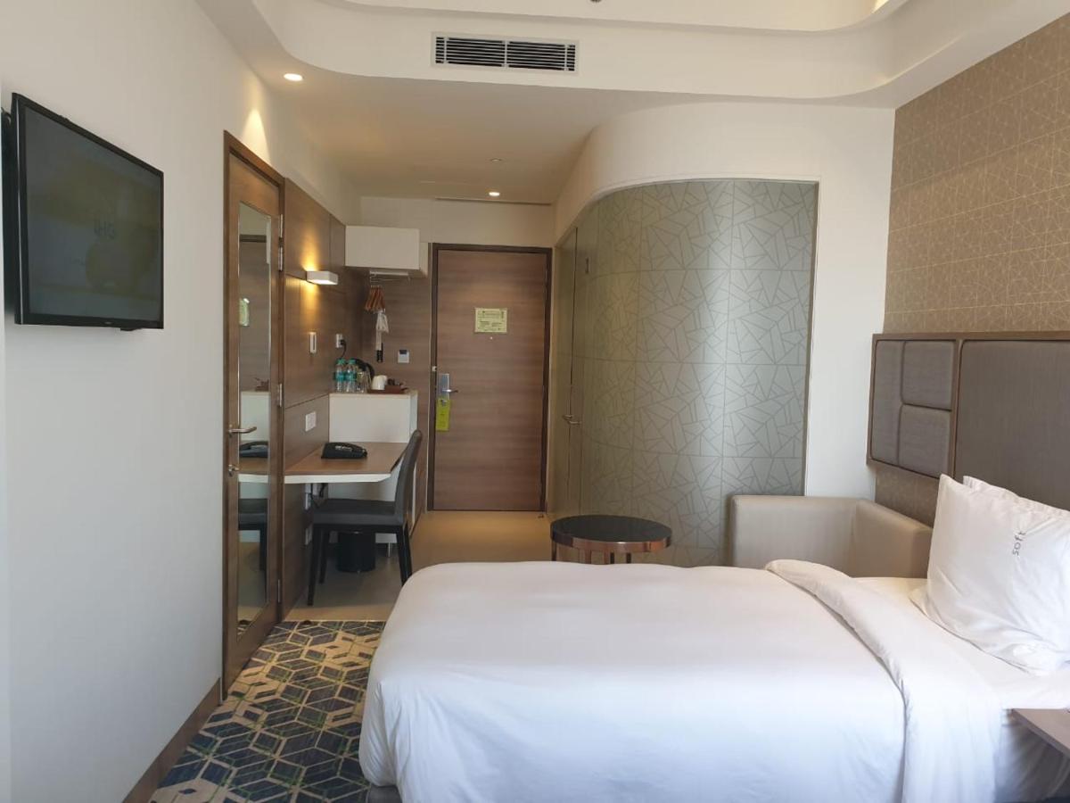 a hotel room with a bed and a kitchen at Holiday Inn Gurugram Sector 90 by IHG in Gurgaon