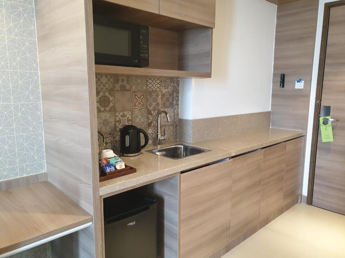 a small kitchen with a sink and a microwave at Holiday Inn Gurugram Sector 90 by IHG in Gurgaon