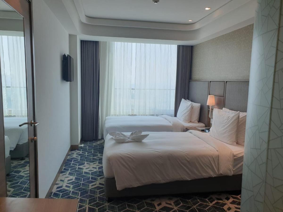 a hotel room with two beds and a window at Holiday Inn Gurugram Sector 90 by IHG in Gurgaon