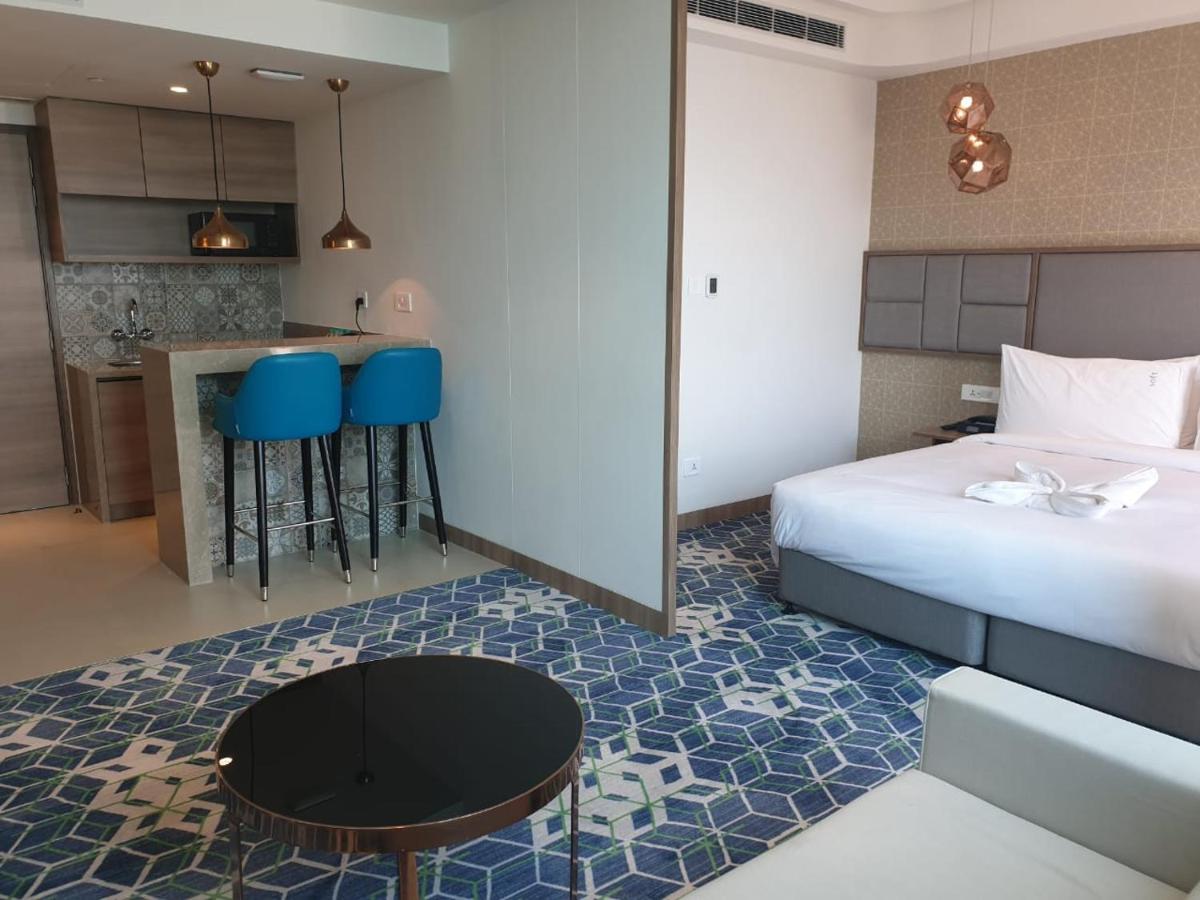 a hotel room with a bed and a kitchen at Holiday Inn Gurugram Sector 90 by IHG in Gurgaon