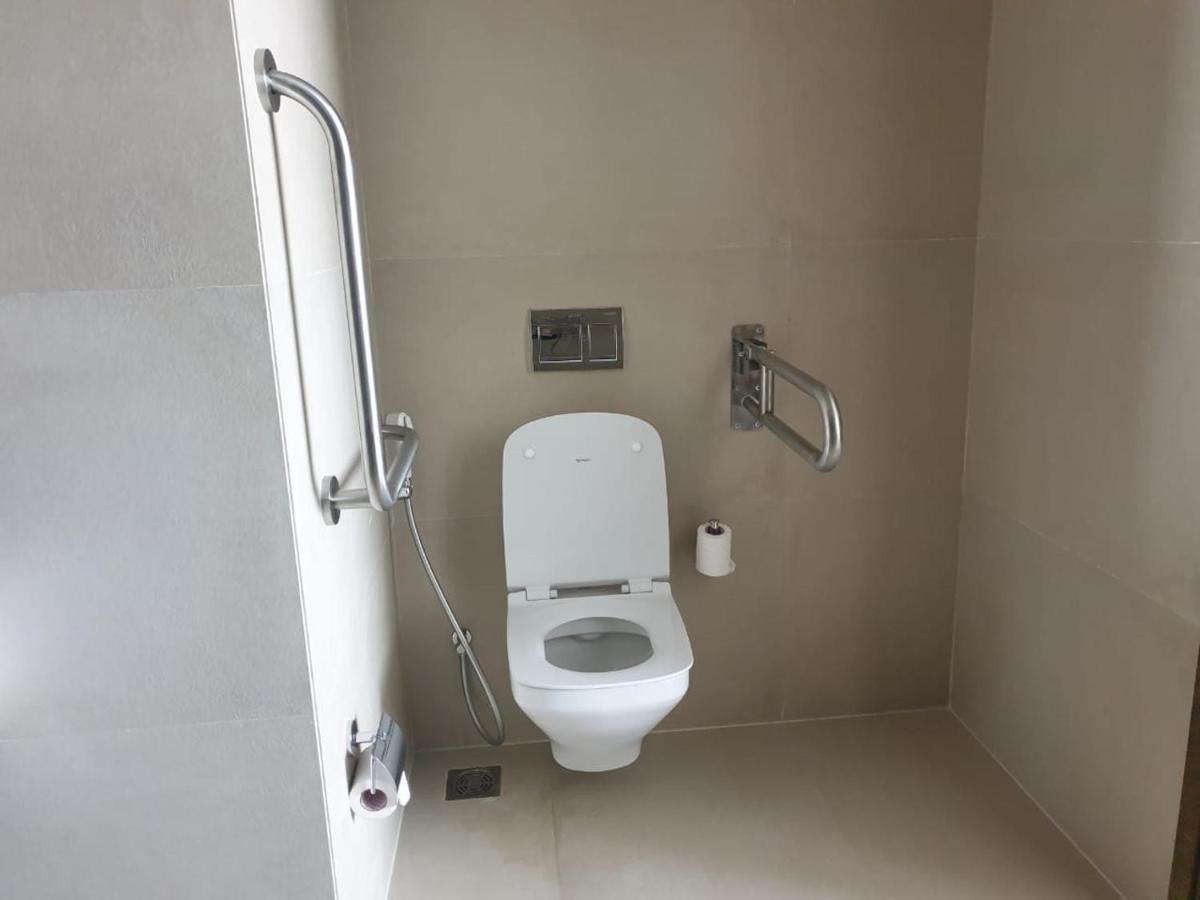 a bathroom with a white toilet in a stall at Holiday Inn Gurugram Sector 90 by IHG in Gurgaon