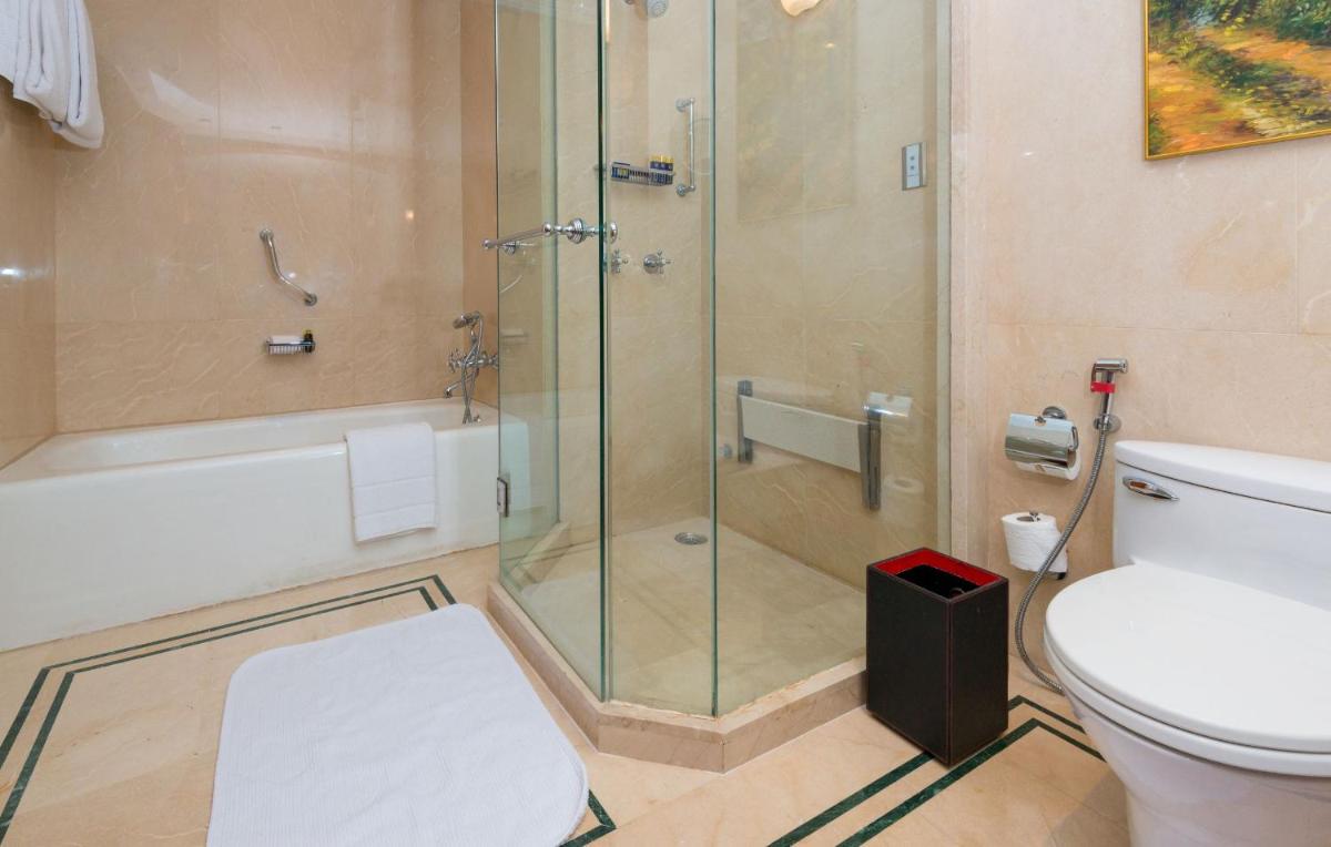 a bathroom with a shower and a toilet at The Oberoi Bengaluru in Bengaluru a bathroom with a shower and a toilet at The Oberoi Bengaluru in Bengaluru