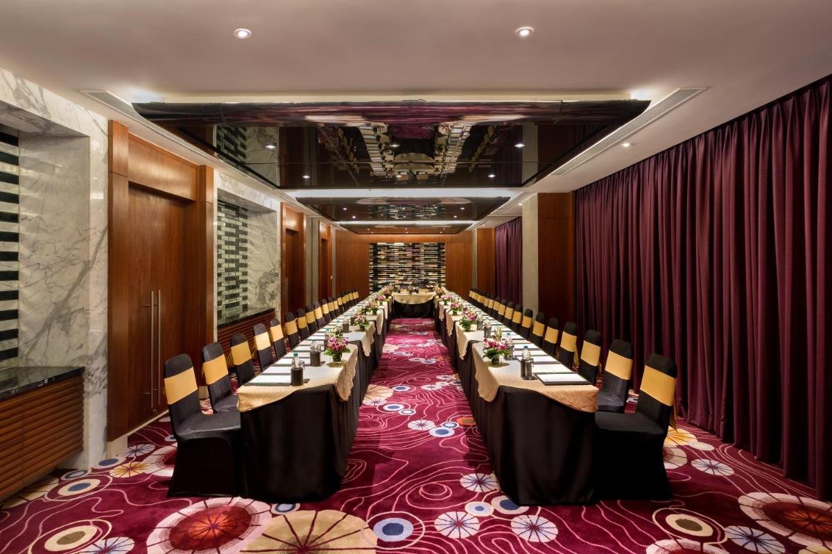 a conference room with long tables and chairs at Holiday Inn Jaipur City Centre by IHG in Jaipur a conference room with long tables and chairs at Holiday Inn Jaipur City Centre by IHG in Jaipur