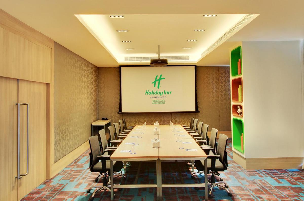 a conference room with a long table and chairs at Holiday Inn Bengaluru Racecourse by IHG in Bengaluru a conference room with a long table and chairs at Holiday Inn Bengaluru Racecourse by IHG in Bengaluru