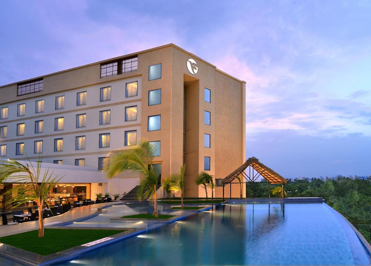 a hotel with a swimming pool in front of a building at Fortune Select Grand Ridge, Tirupati - Member ITC Hotels' Group in Tirupati