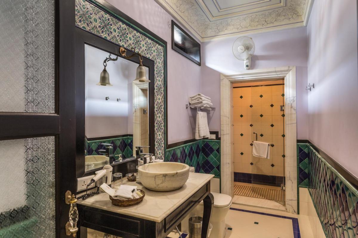 a bathroom with a sink and a toilet and a mirror at Royal Heritage Haveli - By Leisure Hotels in Jaipur