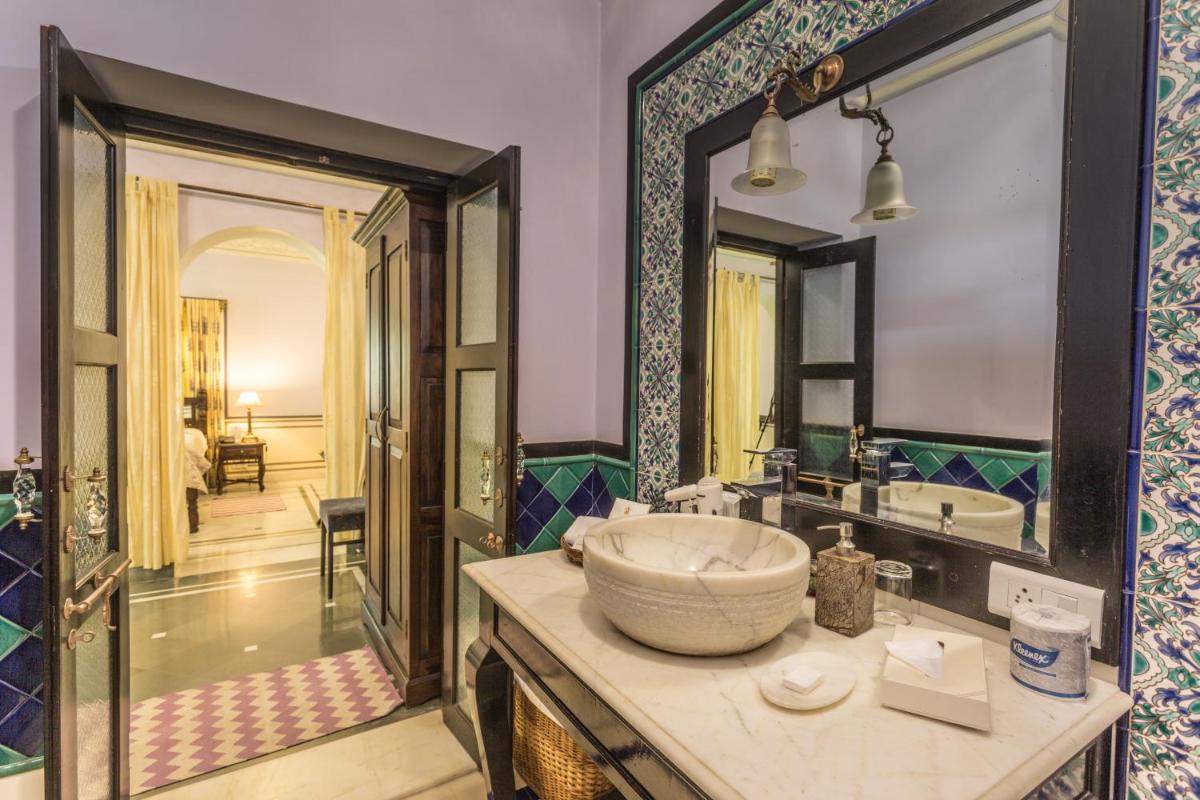 a bathroom with a large sink and a large mirror at Royal Heritage Haveli - By Leisure Hotels in Jaipur